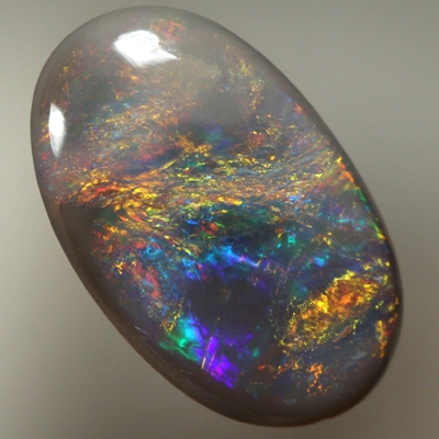 SOLID BLACK OPAL Bright reds over blue with orange and green